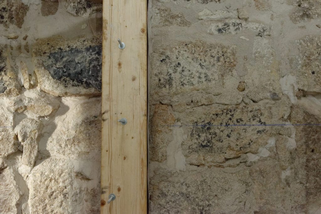 Stone wall with timber reinforcement