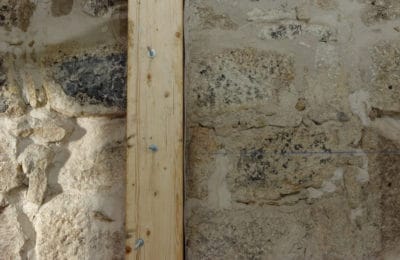 Stone wall with timber reinforcement
