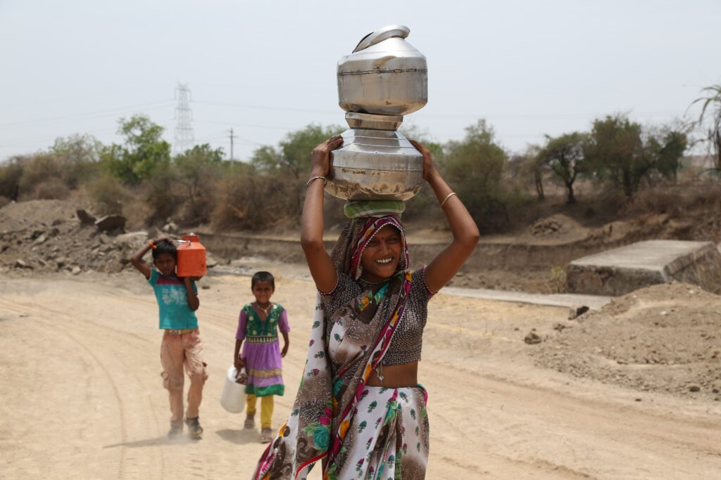 A woman and her children are carrying water